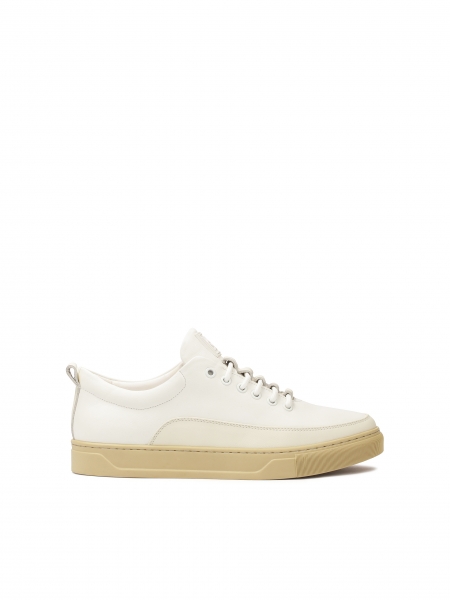 White leather sneakers on a beige sole  AJAKS